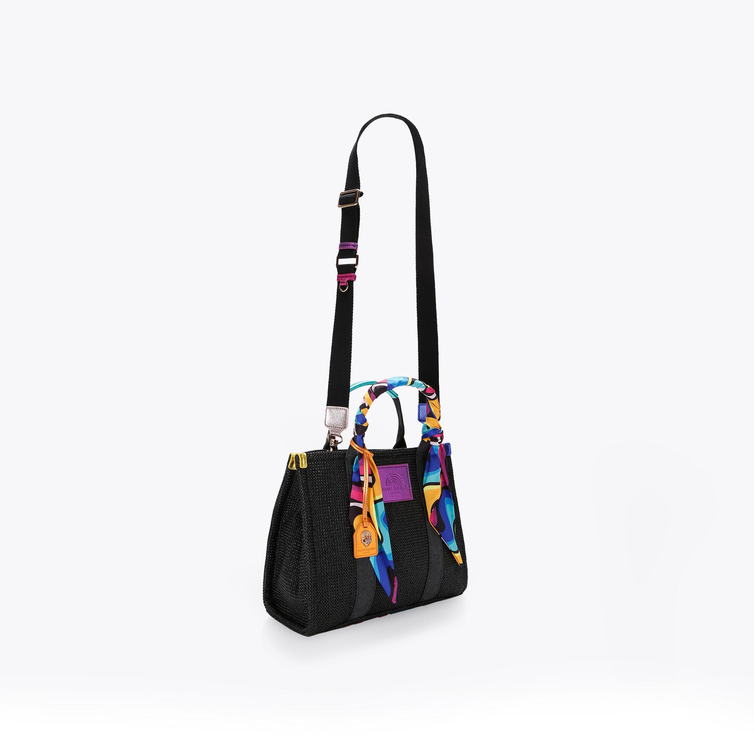 Kurt selling Geiger Rainbow Straw tote